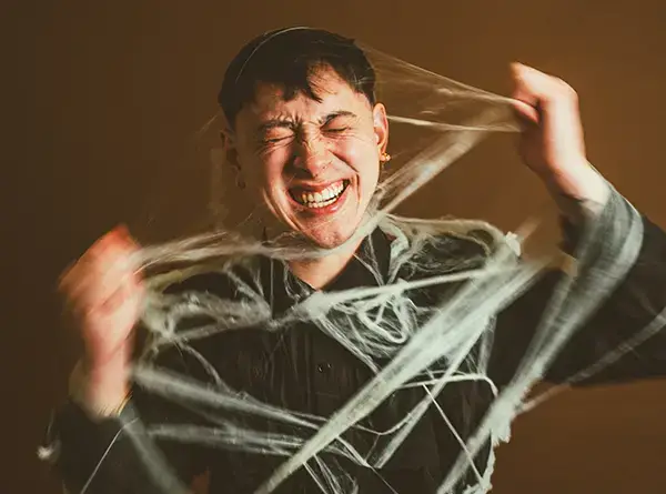 Person entangled in web-like material