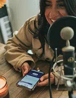 Woman using phone near microphone