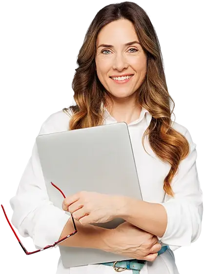 A woman standing with a closed laptop in her arms and a pair of red glasses in her hands.