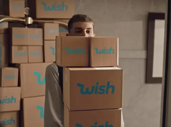 Person carrying stacked Wish boxes